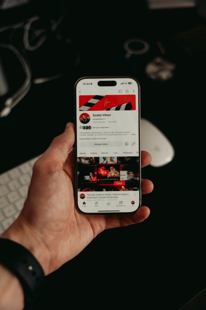 pexels photo 32141317 A hand holding a smartphone displaying a mobile app interface with dark, modern visuals.